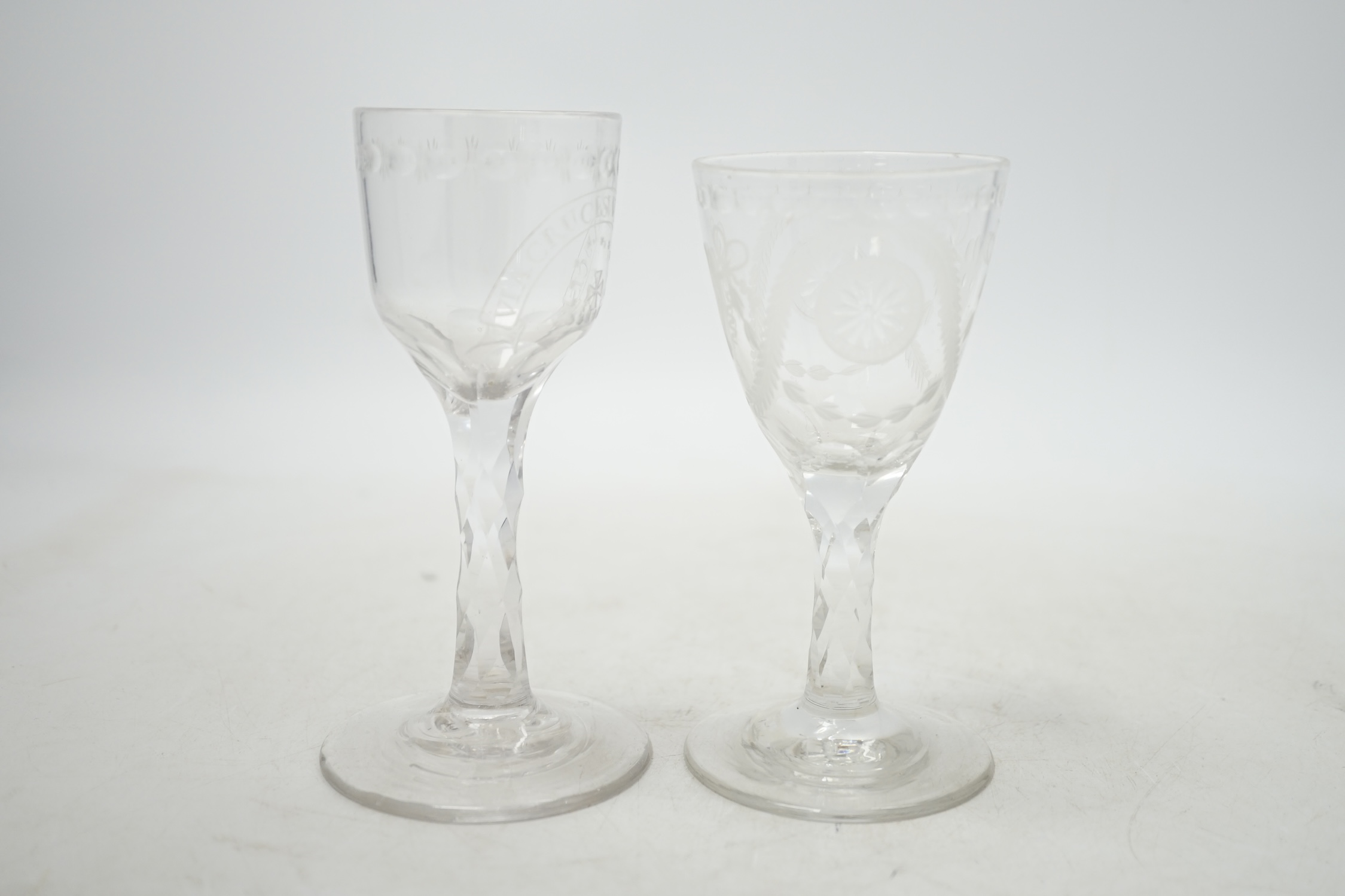 Two 18th century wine glasses with faceted stems, both with engraved bowls, one neo-classical and one reading ‘Via Crucis Via Lucis’, tallest 13.5cm. Condition - good